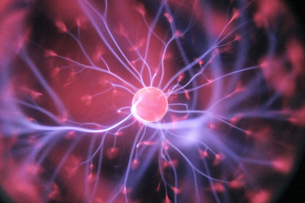 representative image of a neuron with pink and purple electrical charges