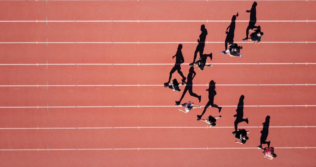 runners on a red track in a V shape